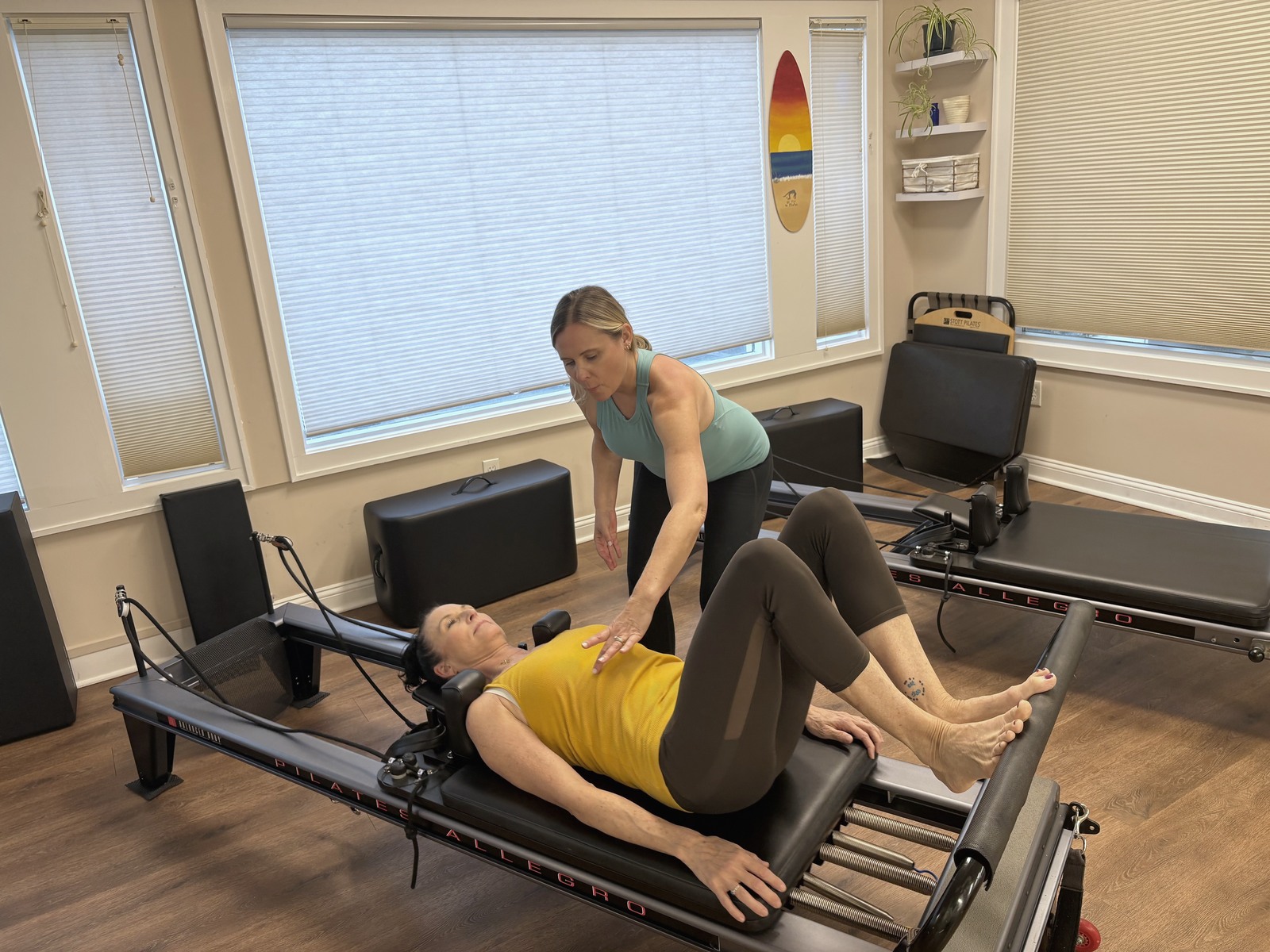 Nicole cueing a client during a reformer exercise.